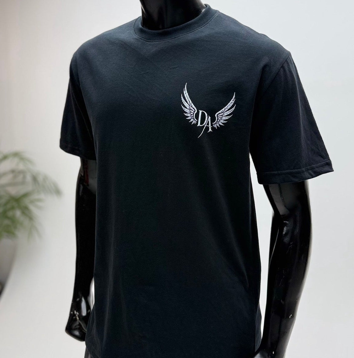 Black Demonic Angel™ Move Properly Tee Front View With Winged DA Chest Mark Editorial View